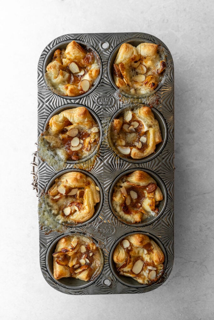 A muffin tin full of freshly baked Mango Chtuney Brie Puff Pastry.