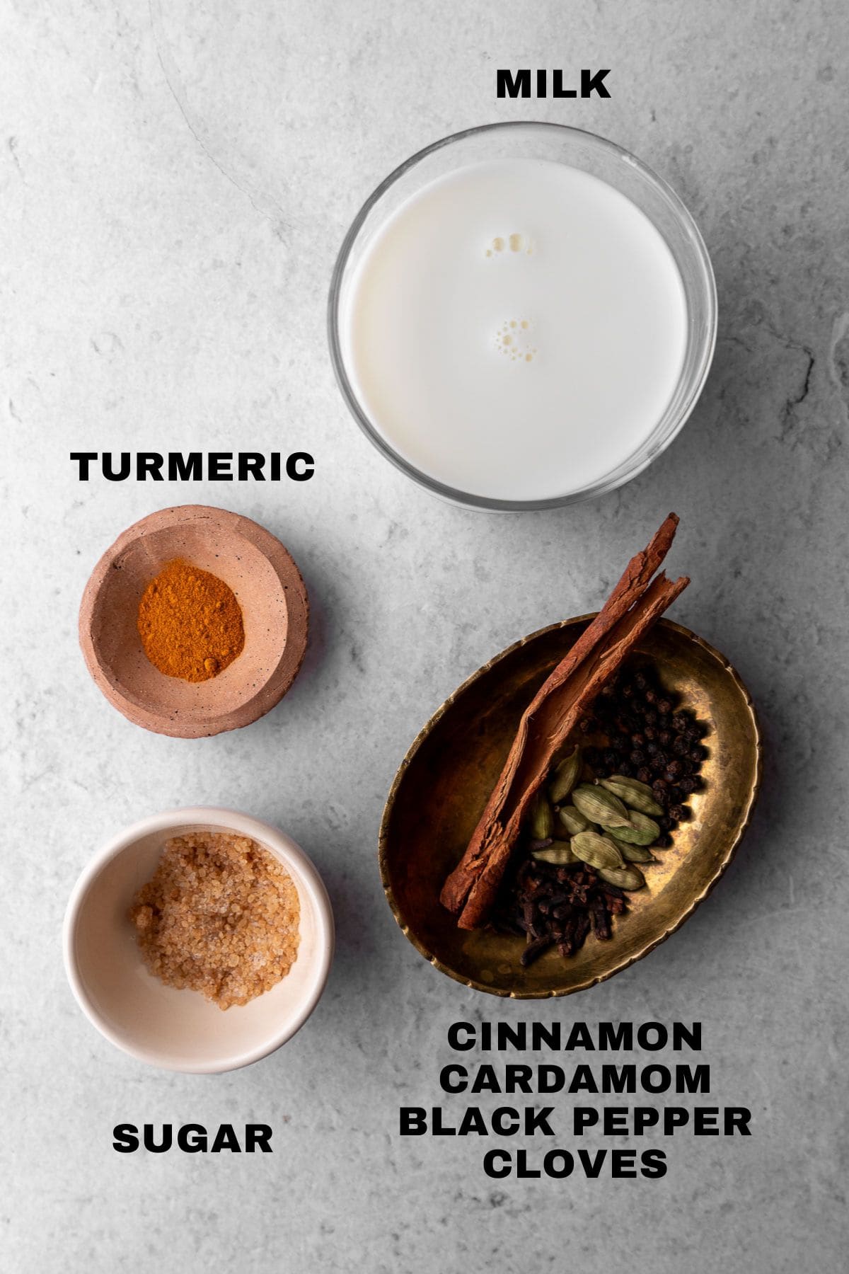 Milk, turmeric, sugar, and spices ingredients with labels.