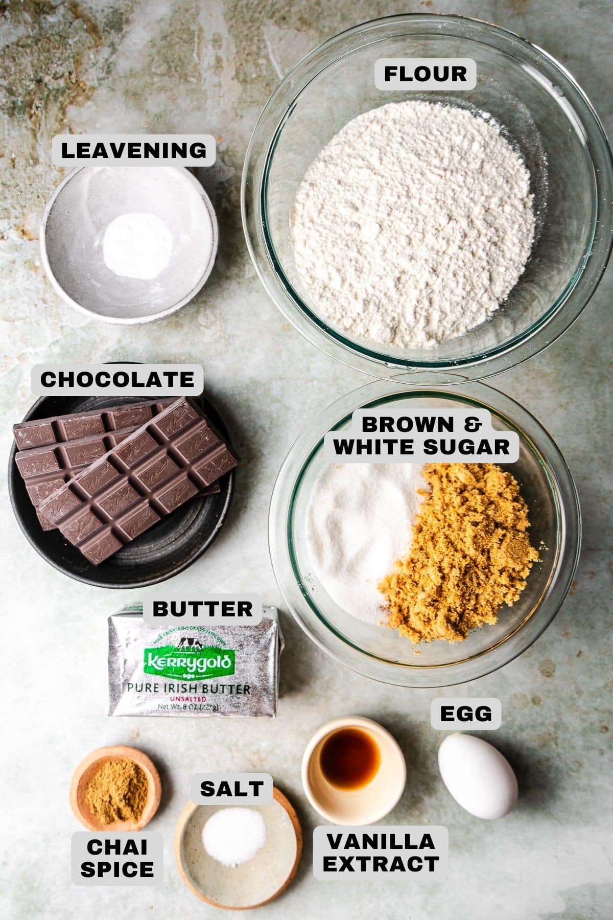 Leavening, flour, chocolate, brown and white sugar, butter, chai spice, salt, vanilla extract, egg ingredients with labels.