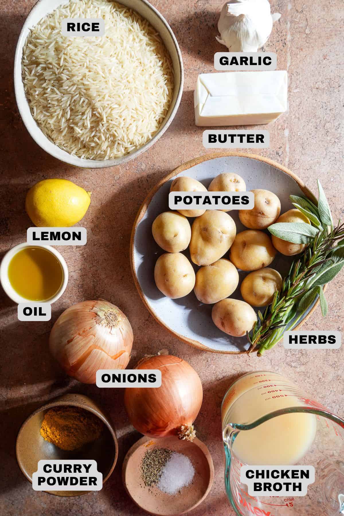 Rice, garlic, butter, potatoes, lemon, oil, onions, herbs, curry powder, chicken broth, salt and pepper ingredients with labels.