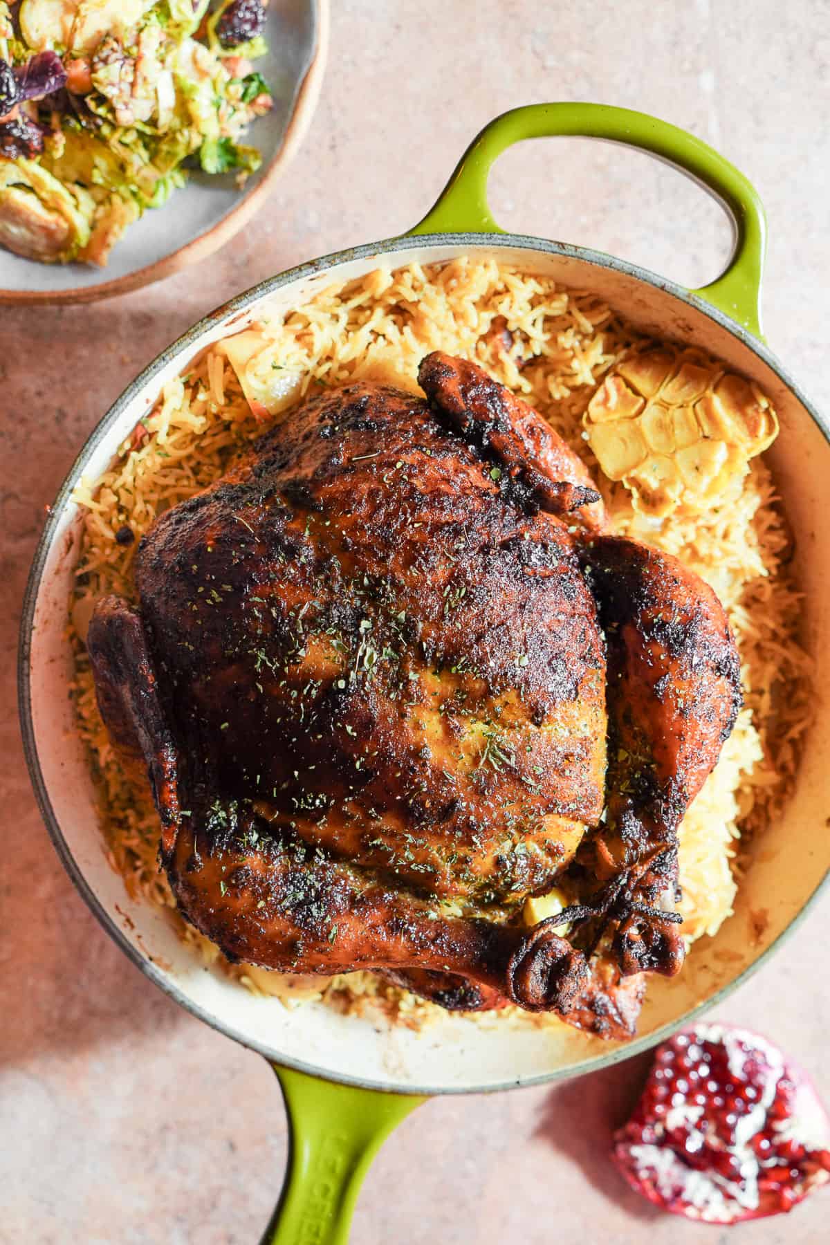 Curried Chicken on top of a bed of rice in a sauce pan.