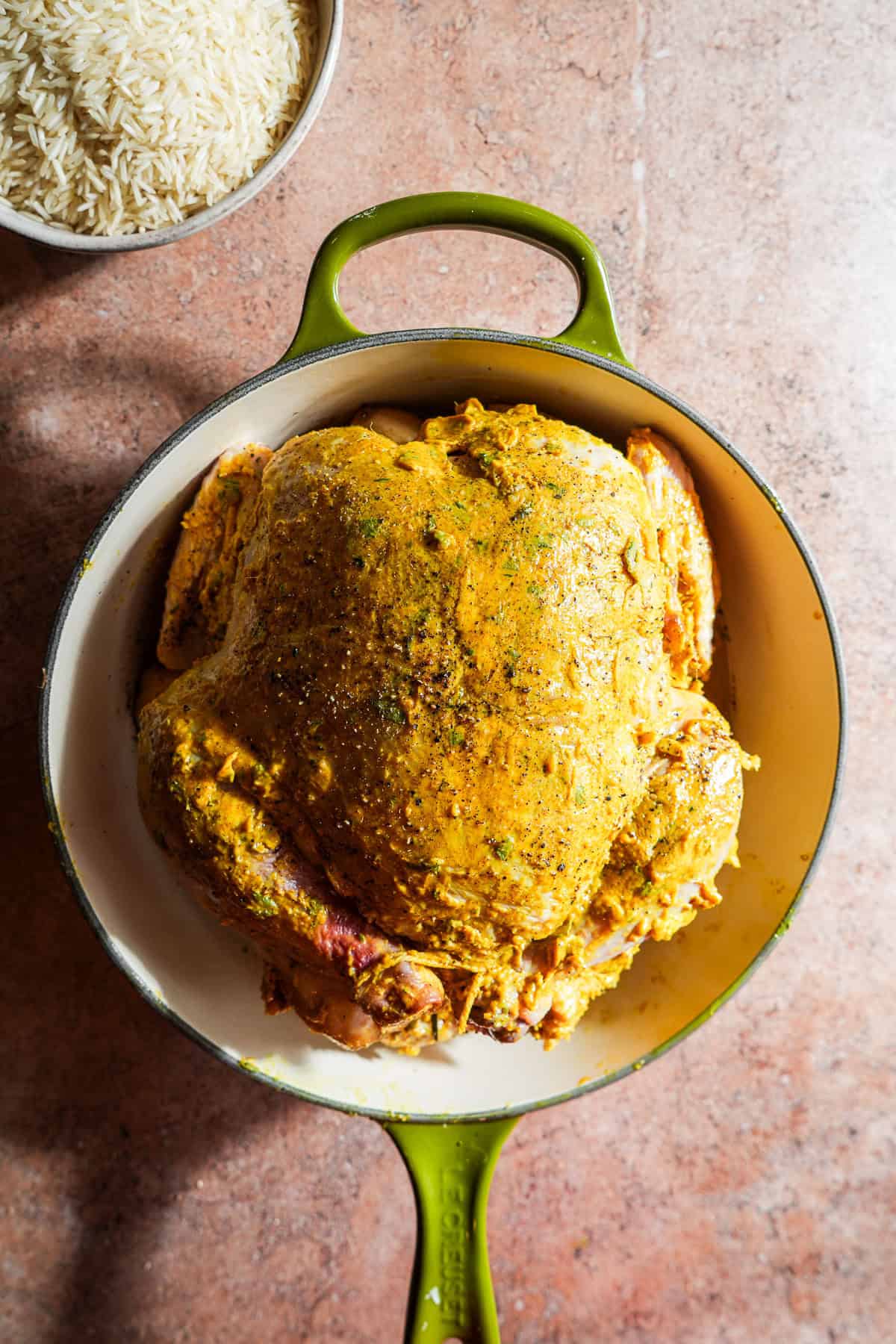 Whole chicken rubbed with a curry butter and trussed in a dutch oven.