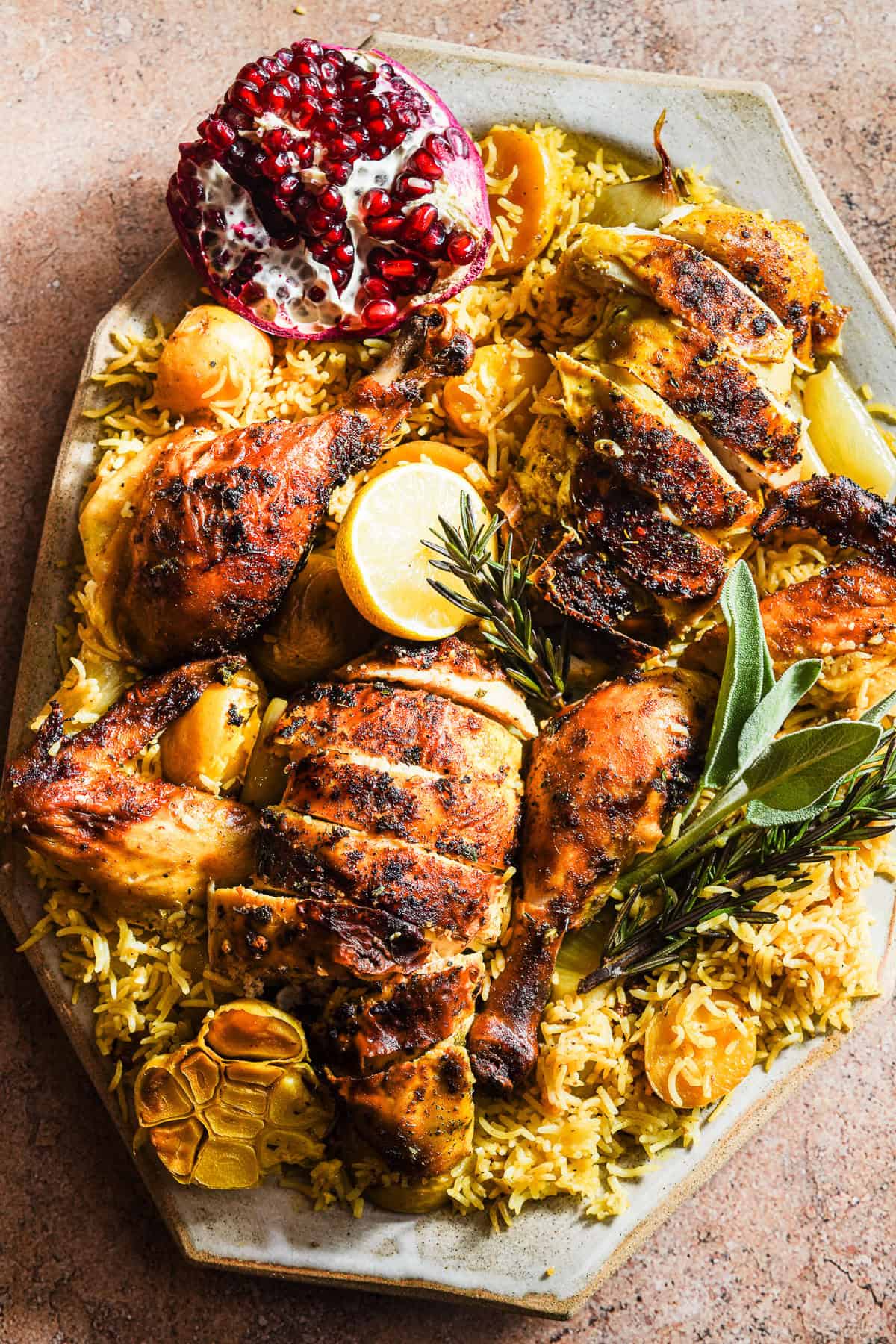 Sliced roast chicken on top of curried rice in a platter.