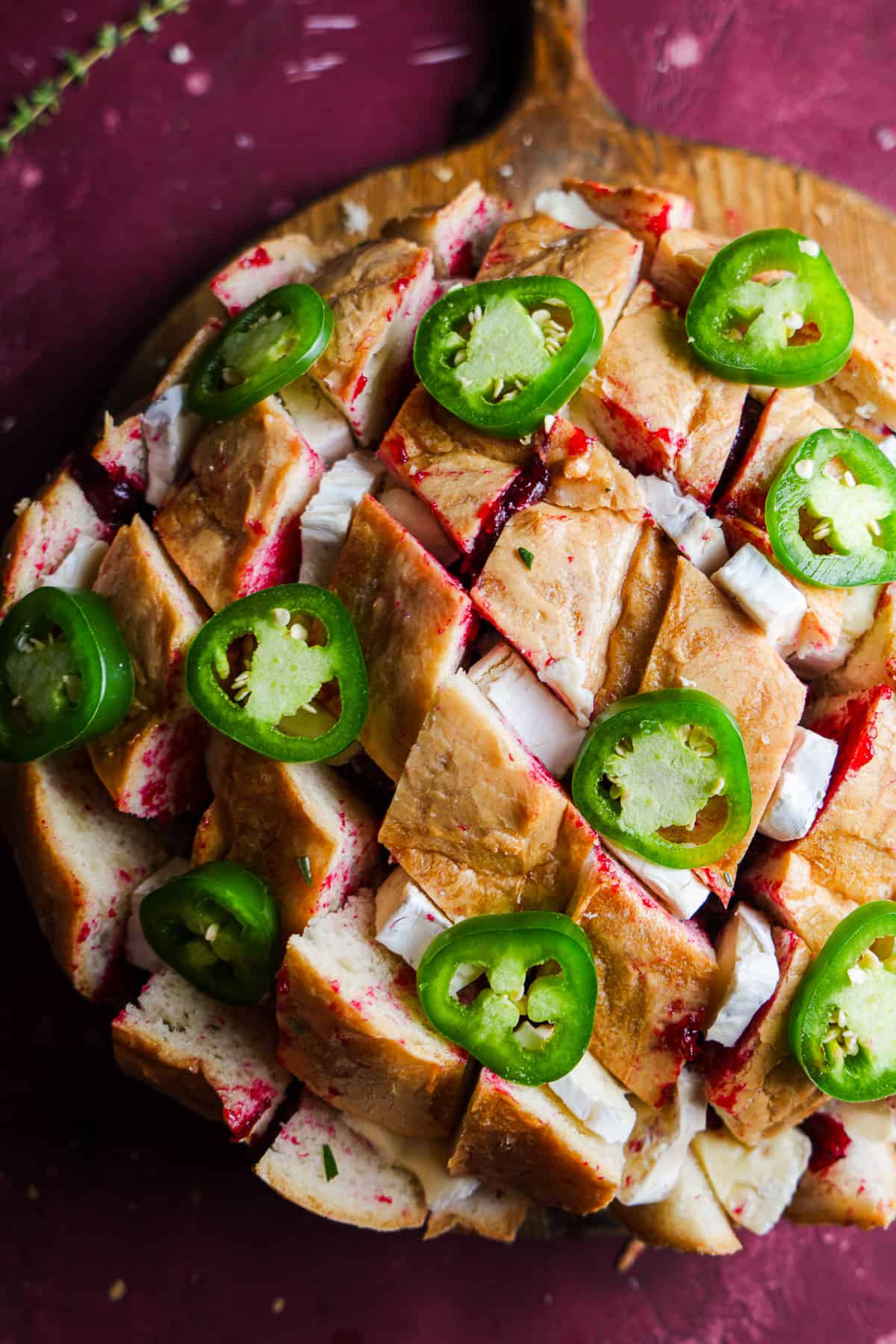 Sliced and stuffed sourdough bread topped with jalapenos.