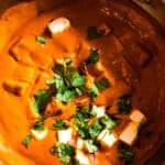 Paneer Butter Masala topped with cilantro in a kadhai.