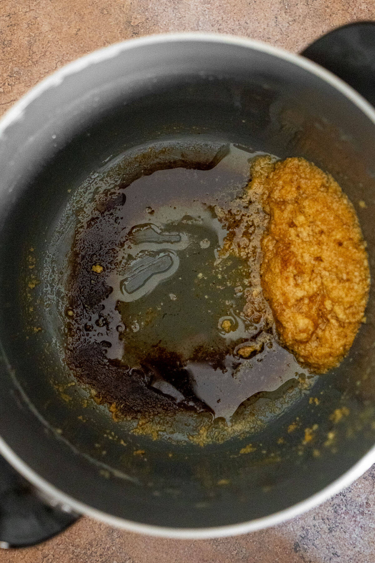 Browned Milk Solids at the Bottom of a Pot
