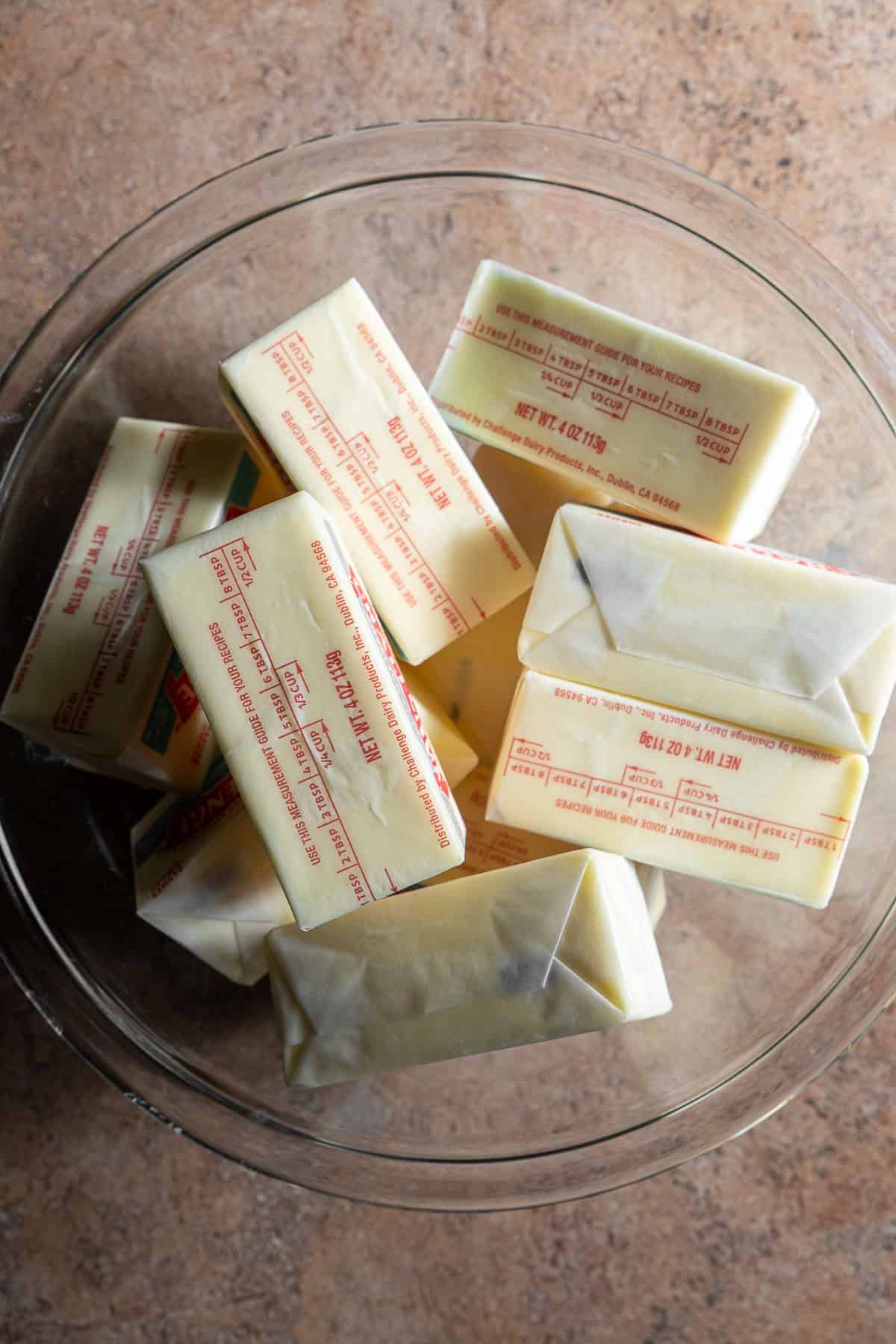 A bowl full of butter sticks.