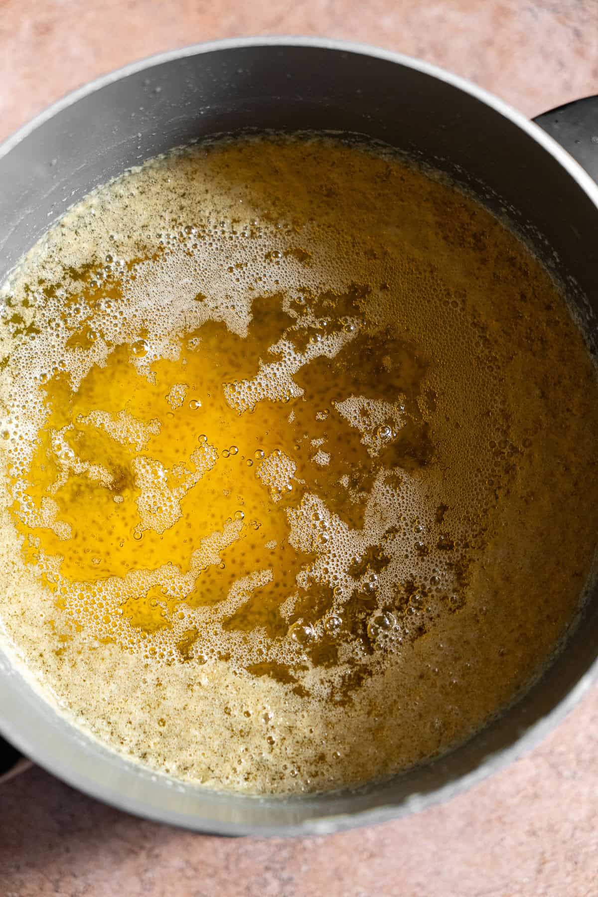 Clear clarified butter with a foamy top.