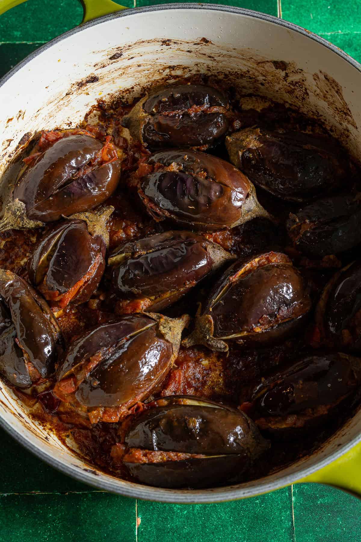 Roasted eggplant stuffed with onion tomato masala in a dutch oven.