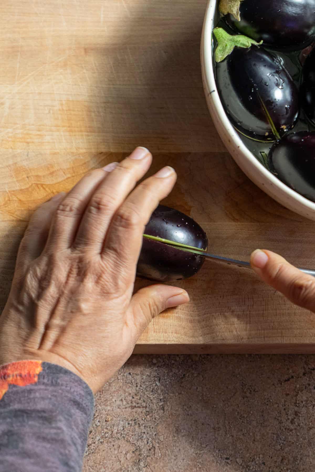 Eggplant sliced in half with the stem intact.
