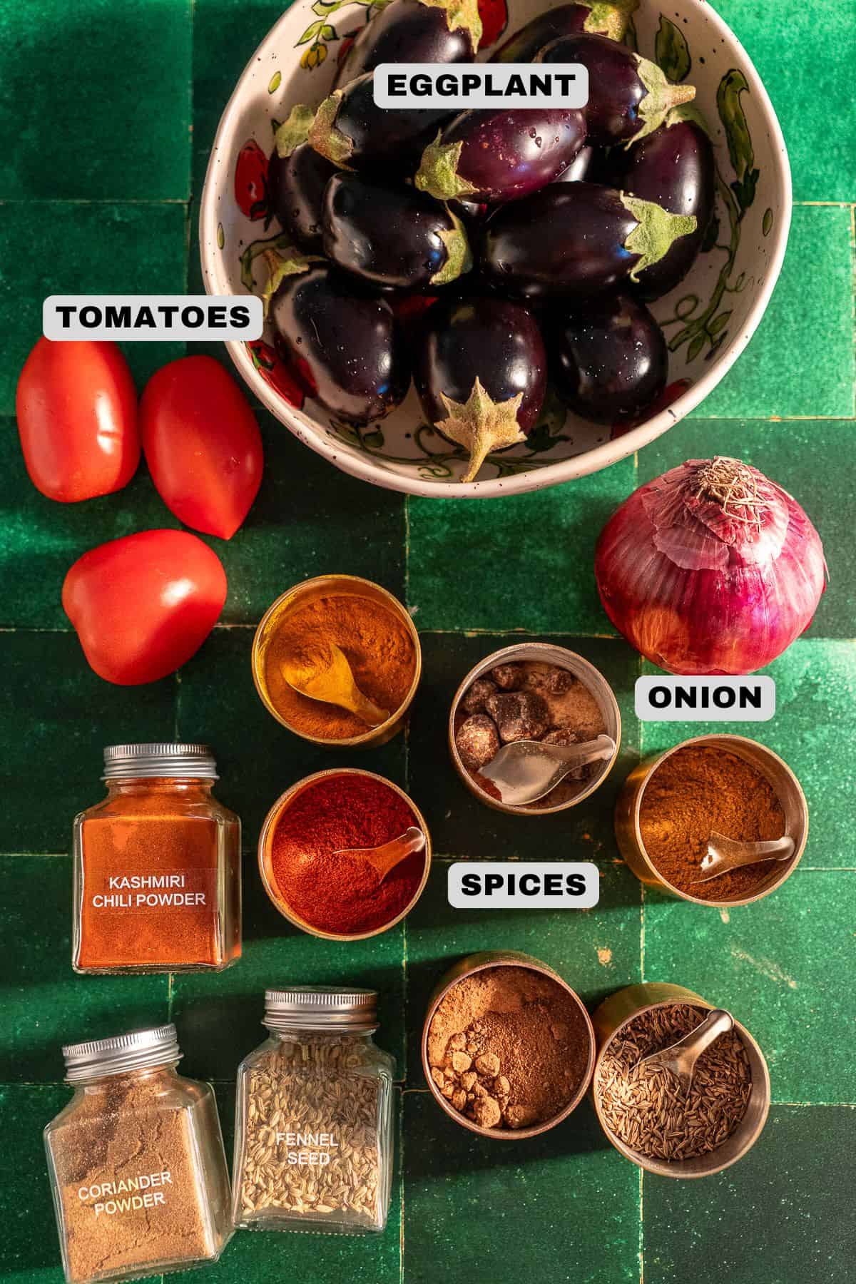 Eggplant, tomatoes, onion, spices ingredients with labels.