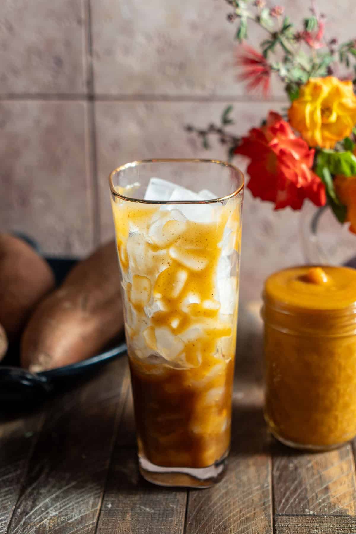 A cup with espresso filled with ice and sweet potato syrup.