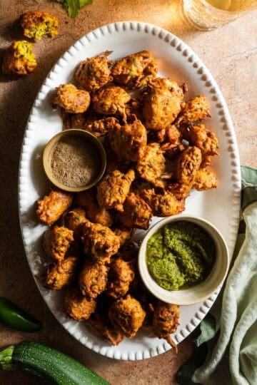 Zucchini fritters in a platter with chutney.