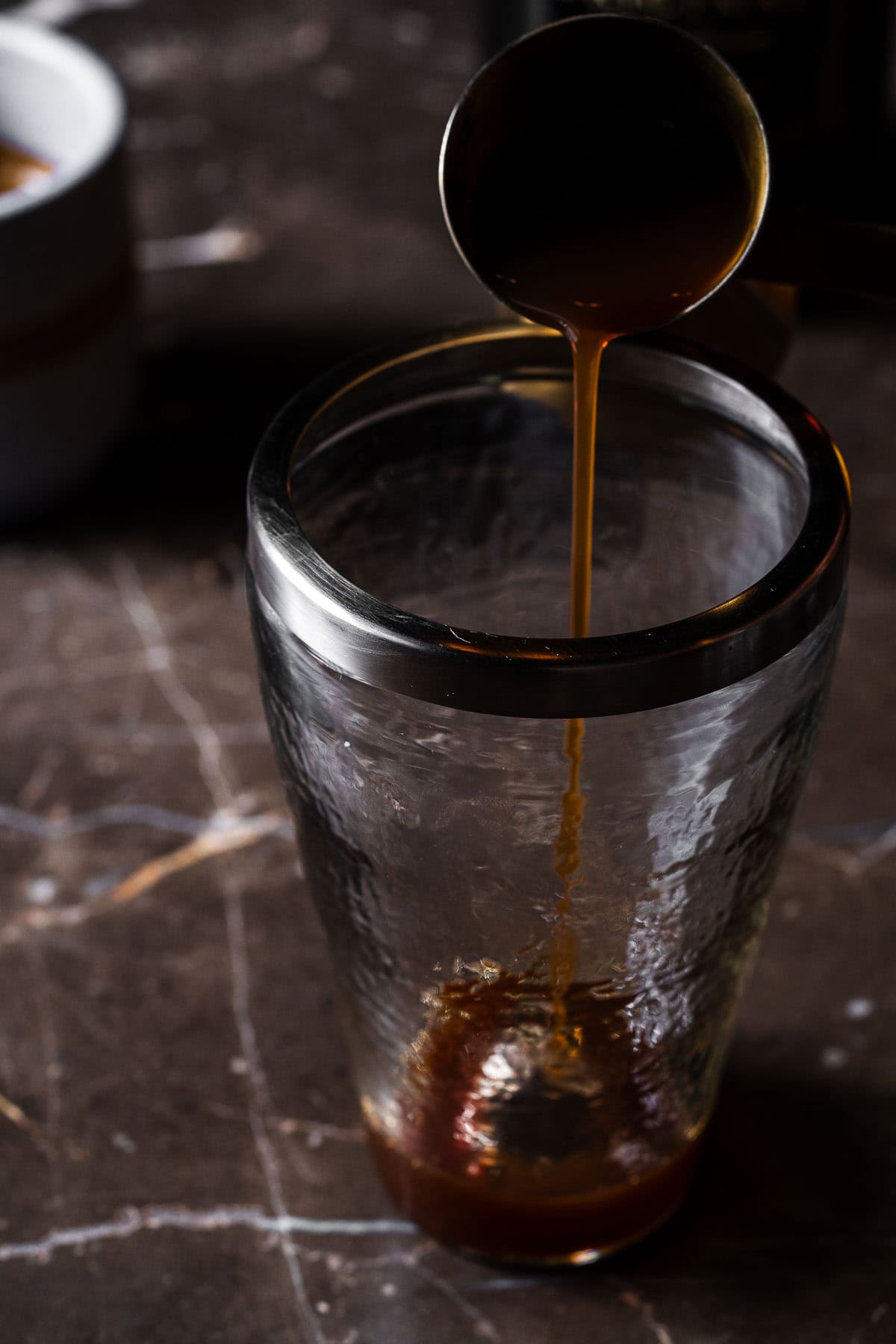 Pour chai concentrate in a cocktail shaker.