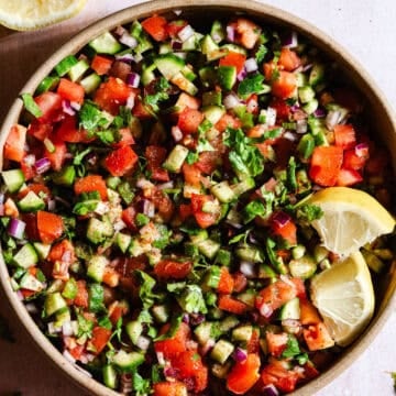 Indian Kachumber salad with lemon wedges.