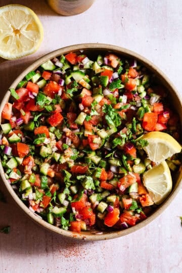 Indian Kachumber salad with lemon wedges.