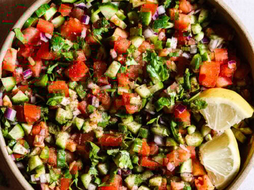 Indian Kachumber salad with lemon wedges.