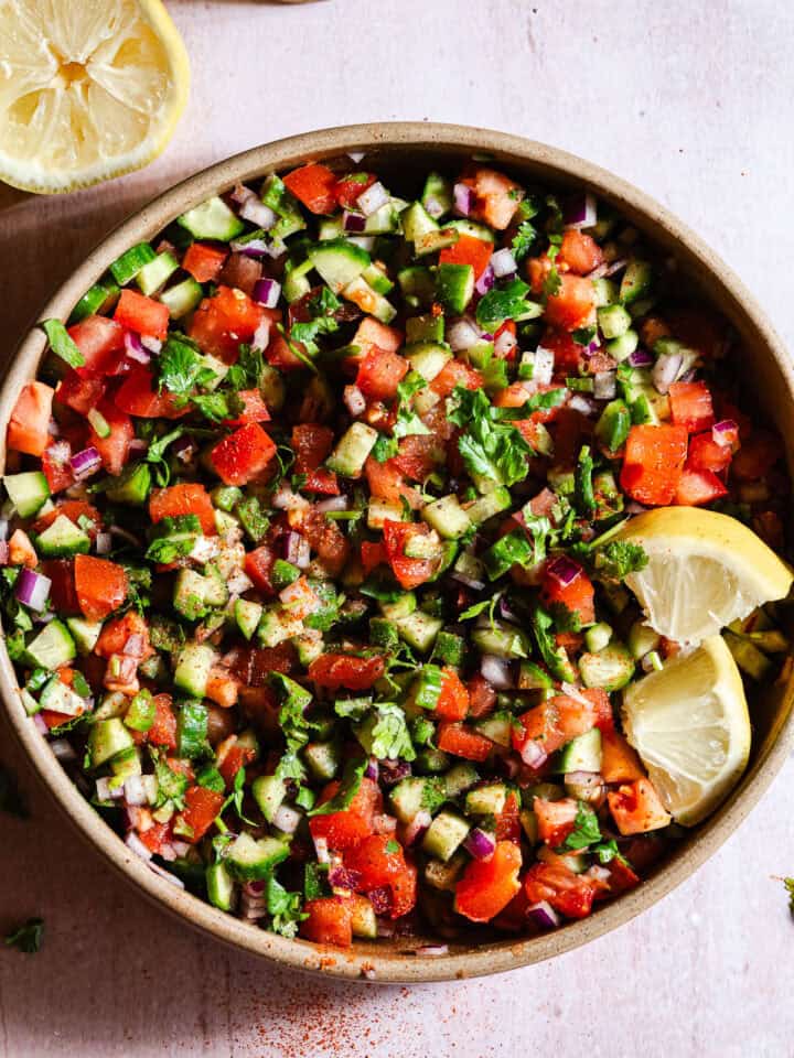 Indian Kachumber salad with lemon wedges.