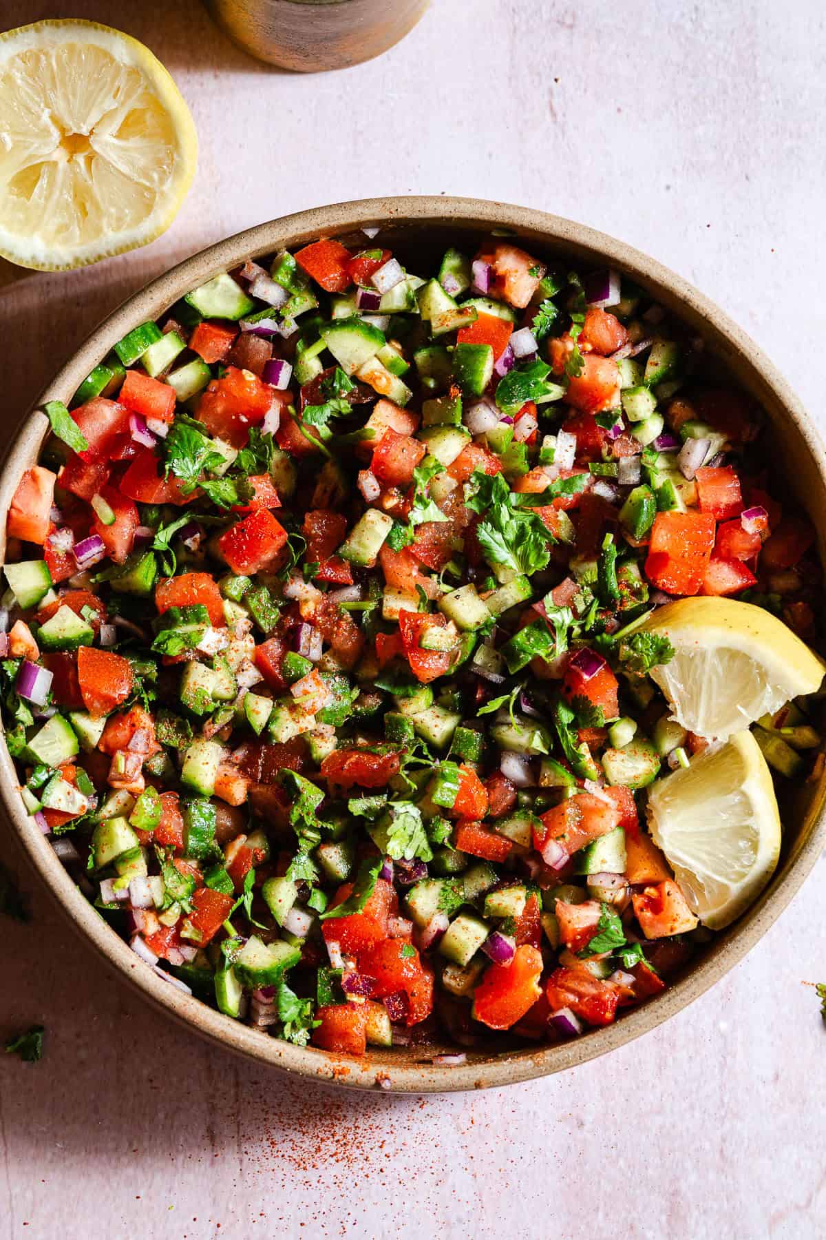 Indian Kachumber salad with lemon wedges.