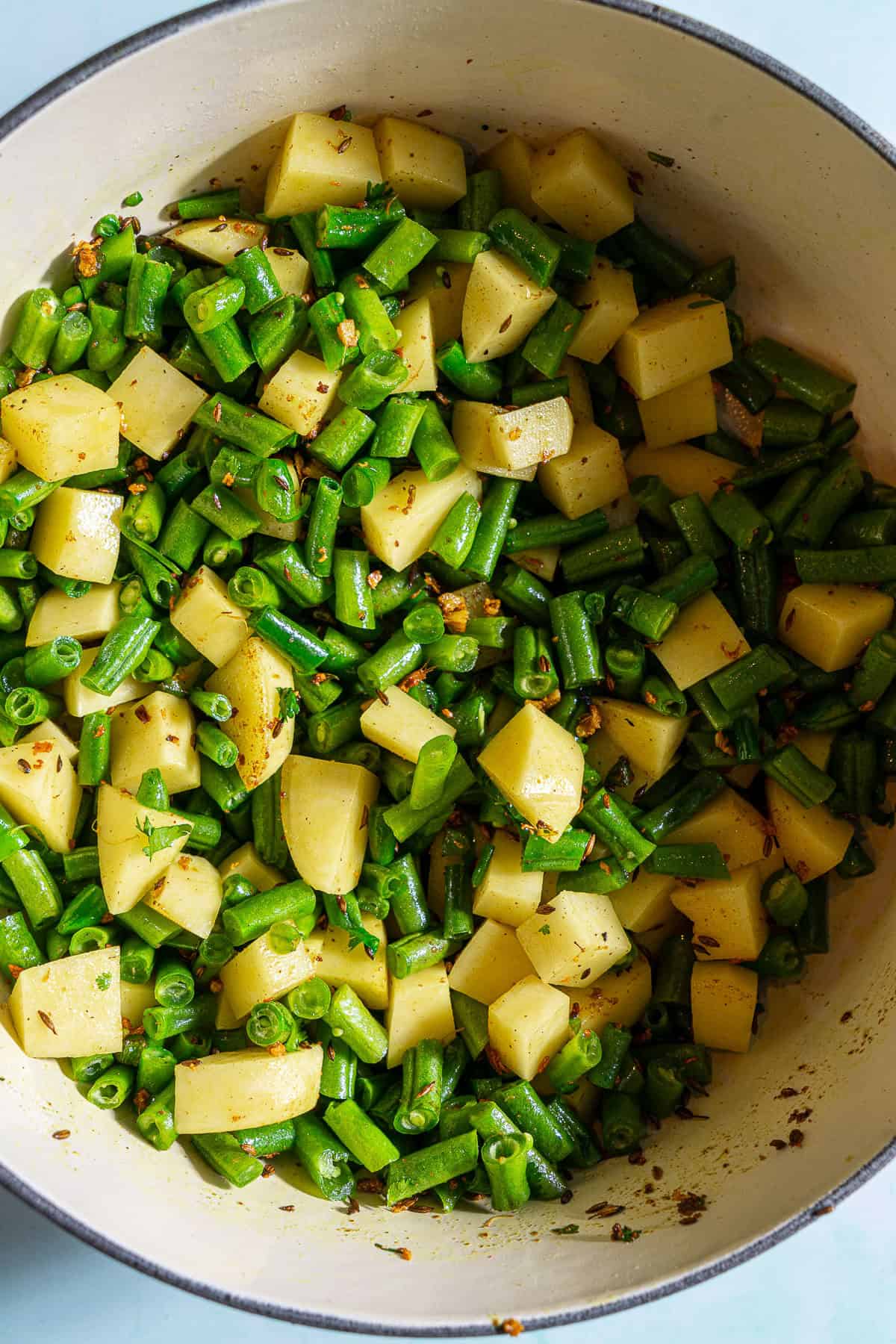Sauteed potatoes with chopped green beans.