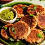 Aloo tikkis in a serving plate with chutney.