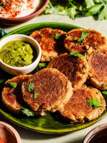 Aloo tikkis in a serving plate with chutney.
