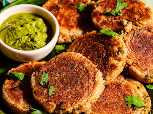 Aloo tikkis in a serving plate with chutney.