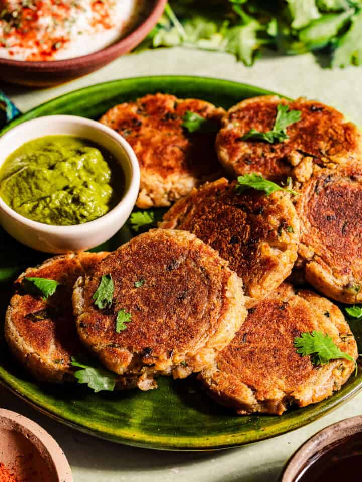 Aloo tikkis in a serving plate with chutney.