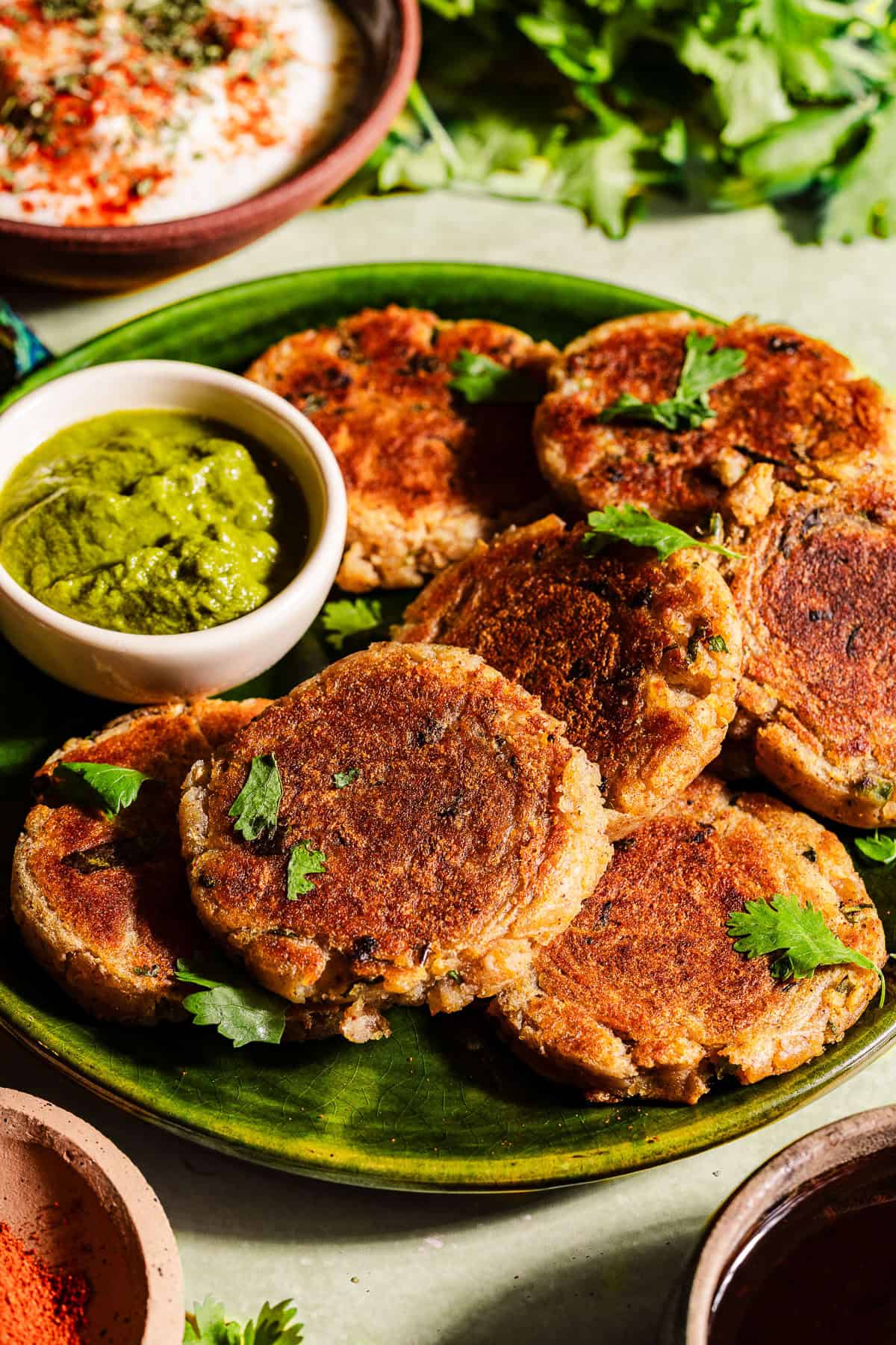 Aloo tikkis in a serving plate with chutney.