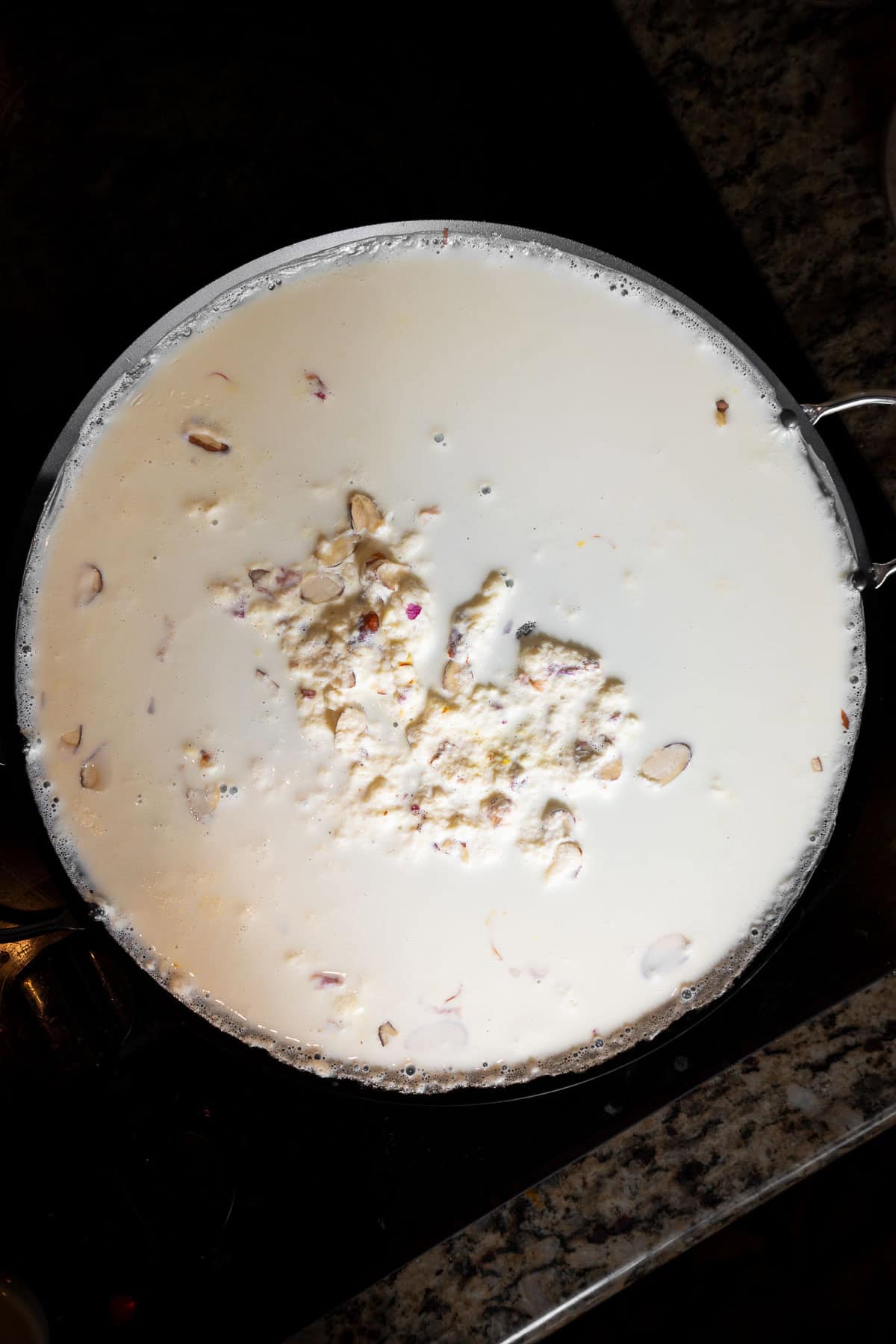 Malai with almonds in a flat pan.