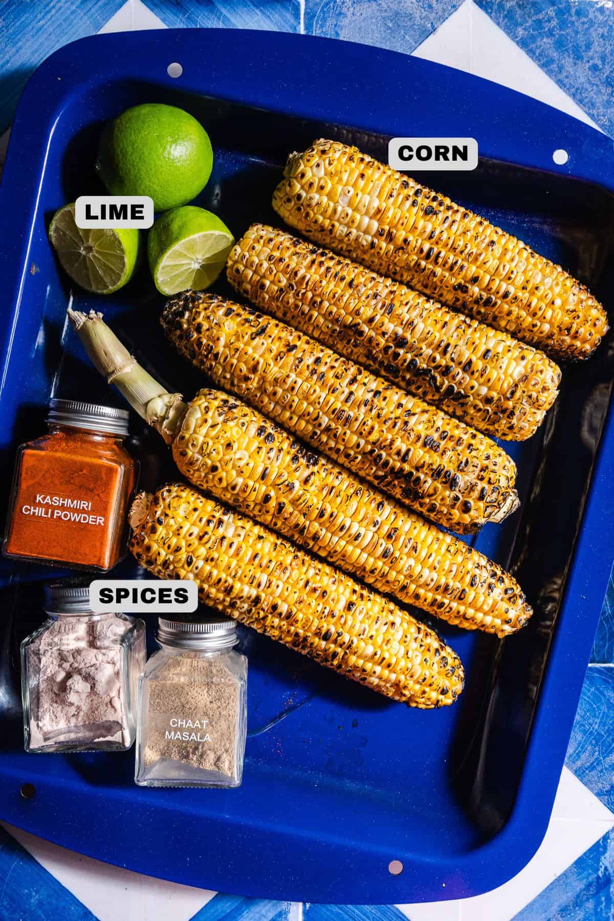 Grilled corn, lime, and spices ingredients with labels.