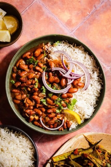 Rajma in a bowl with rice and red onions.