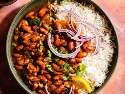 Rajma in a bowl with rice and red onions.