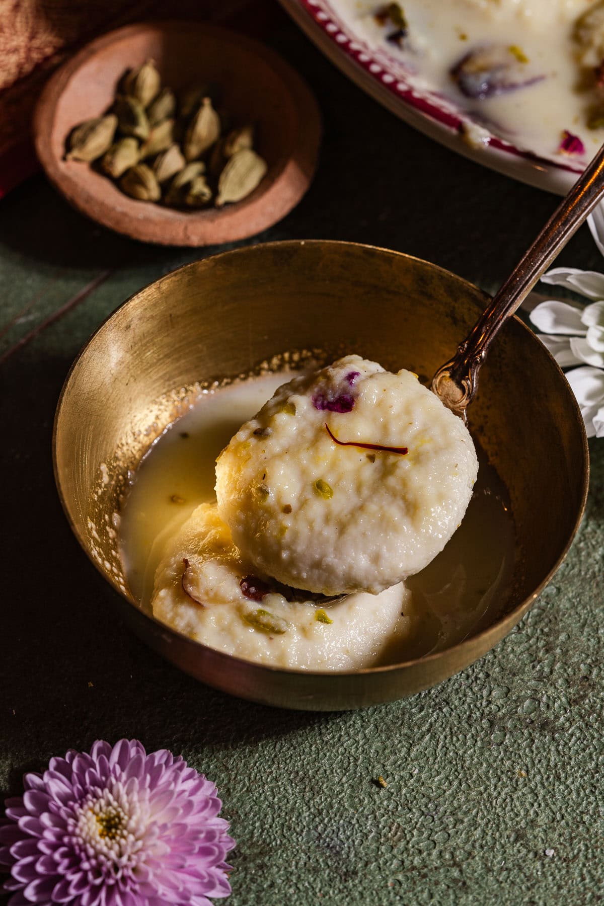 Two pieces of ras malai in a bowl.