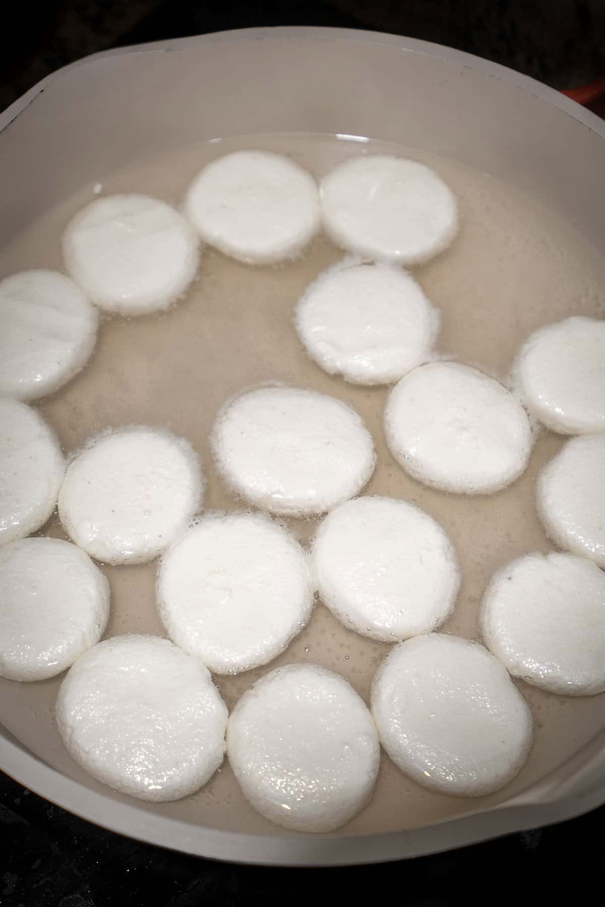 Unboiled chenna dumplings in sugar water.