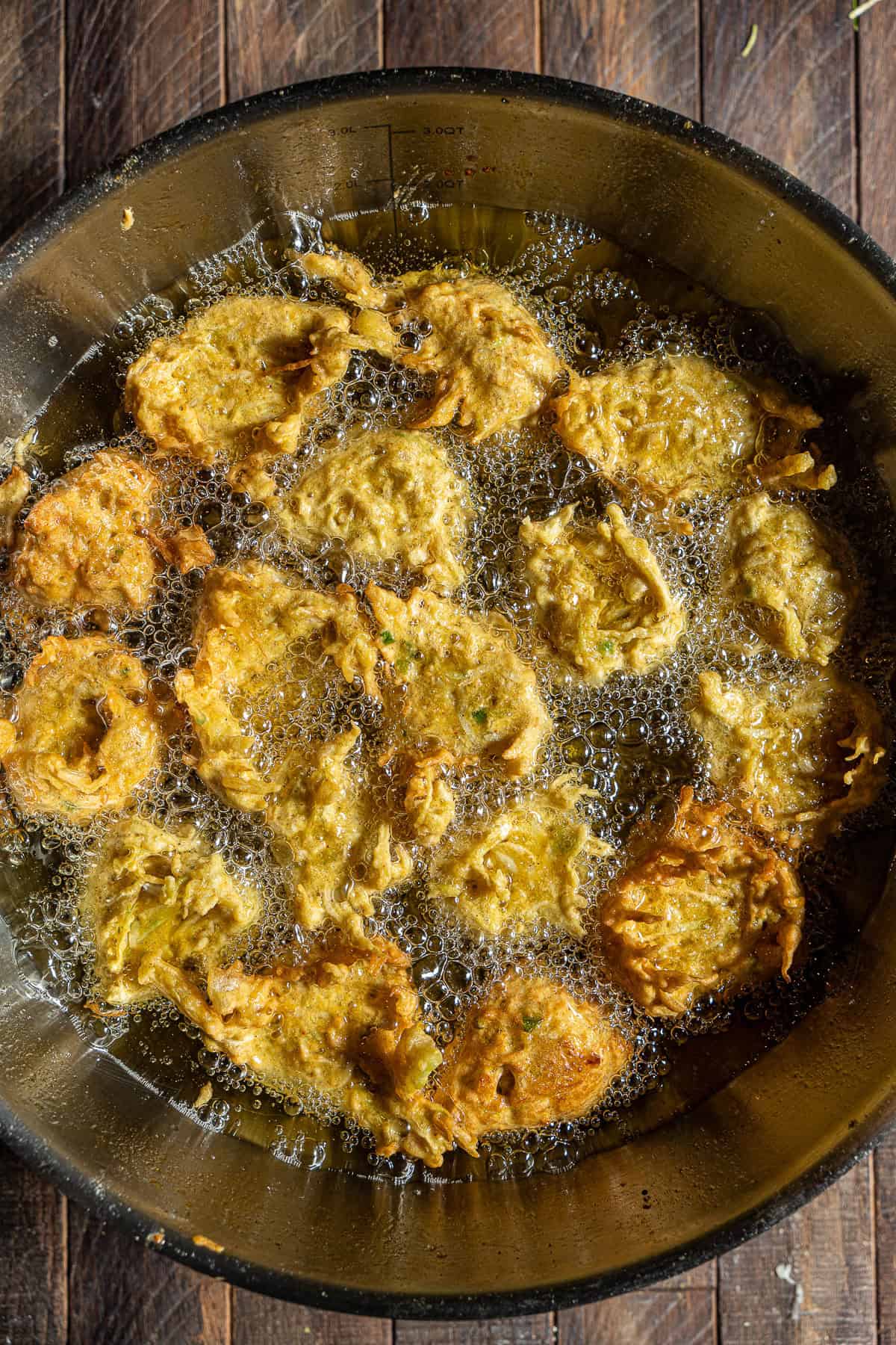 Lauki koftas mid-fry in a kadhai.
