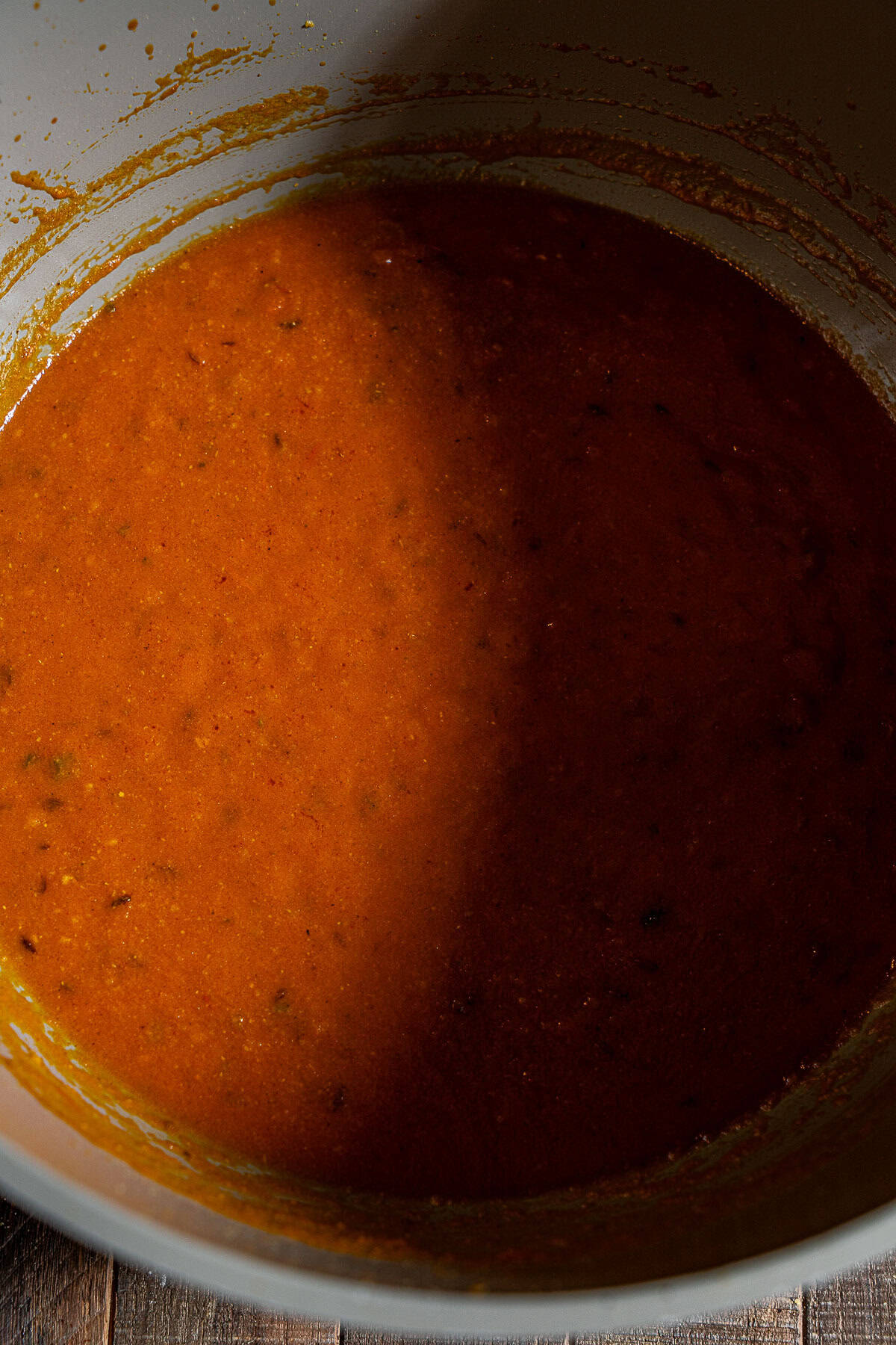 A deep pot with a tomato gravy.