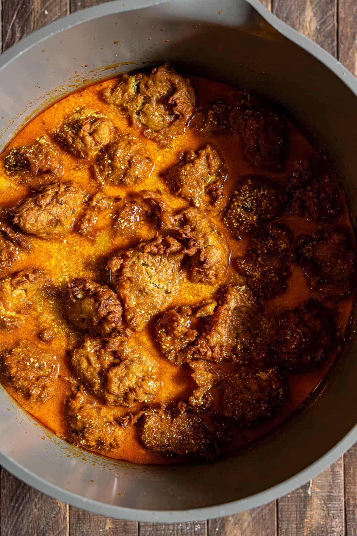 A pot full of lauki koftas in a creamy tomato gravy.