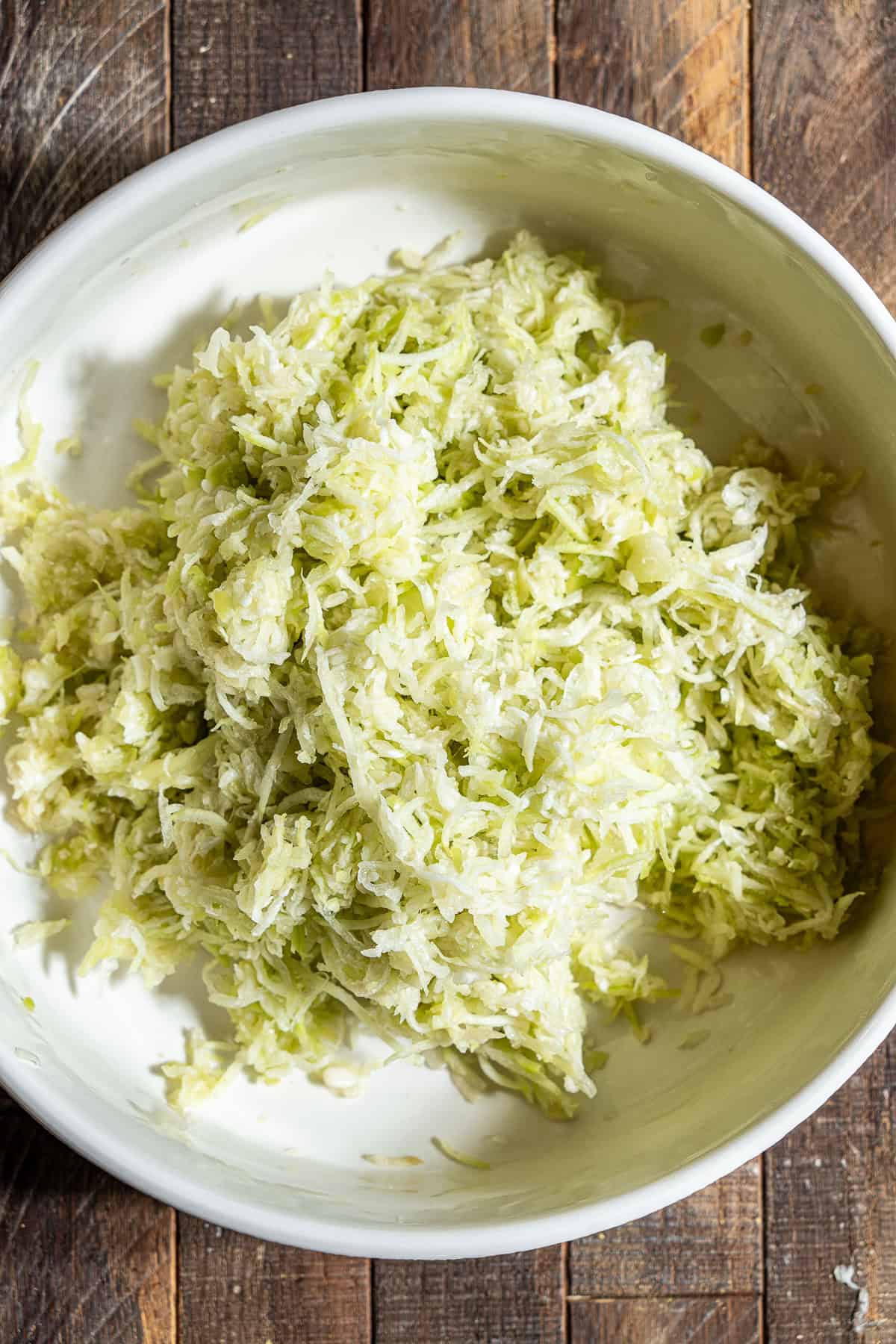 A bowl of shredded bottle gourd that's been wrung of it's moisture.