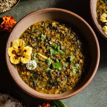 Spinach moong dal in bowls served with rice.