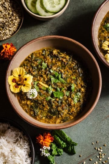 Spinach moong dal in bowls served with rice.