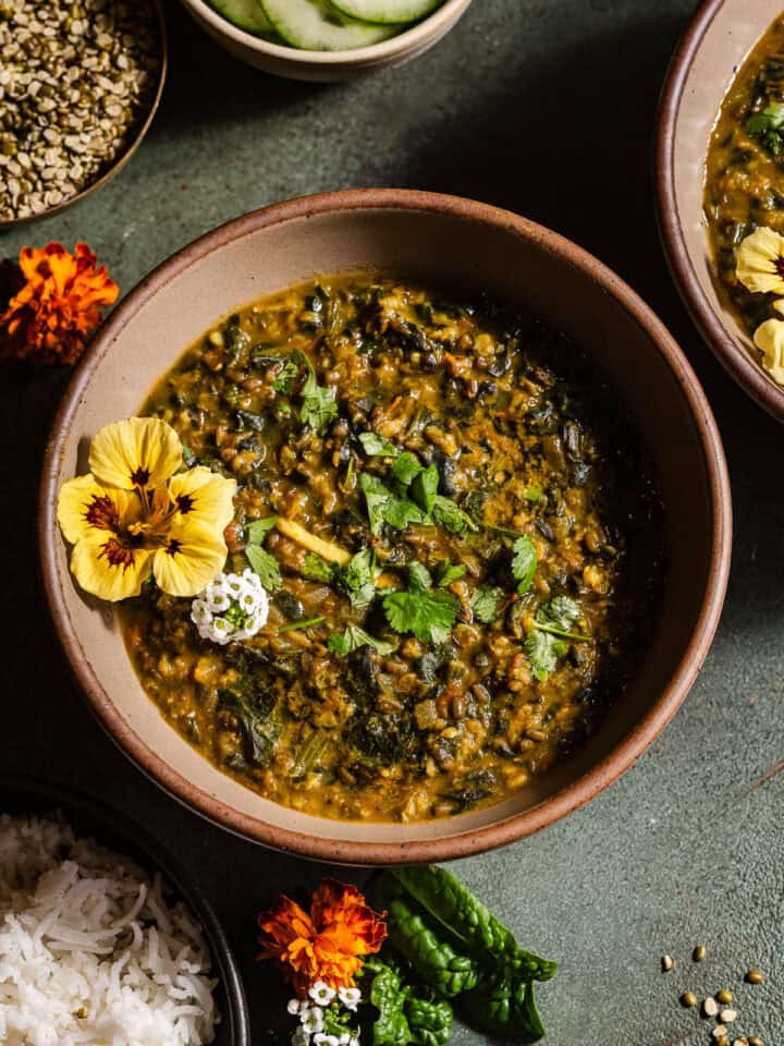 Spinach moong dal in bowls served with rice.