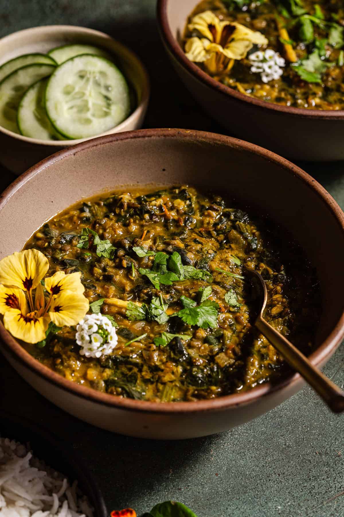 Spinach moong dal in bowls served with rice.