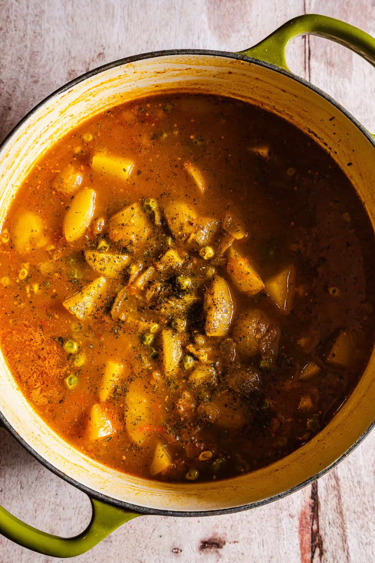 cooked potatoes and peas in tomato gravy.