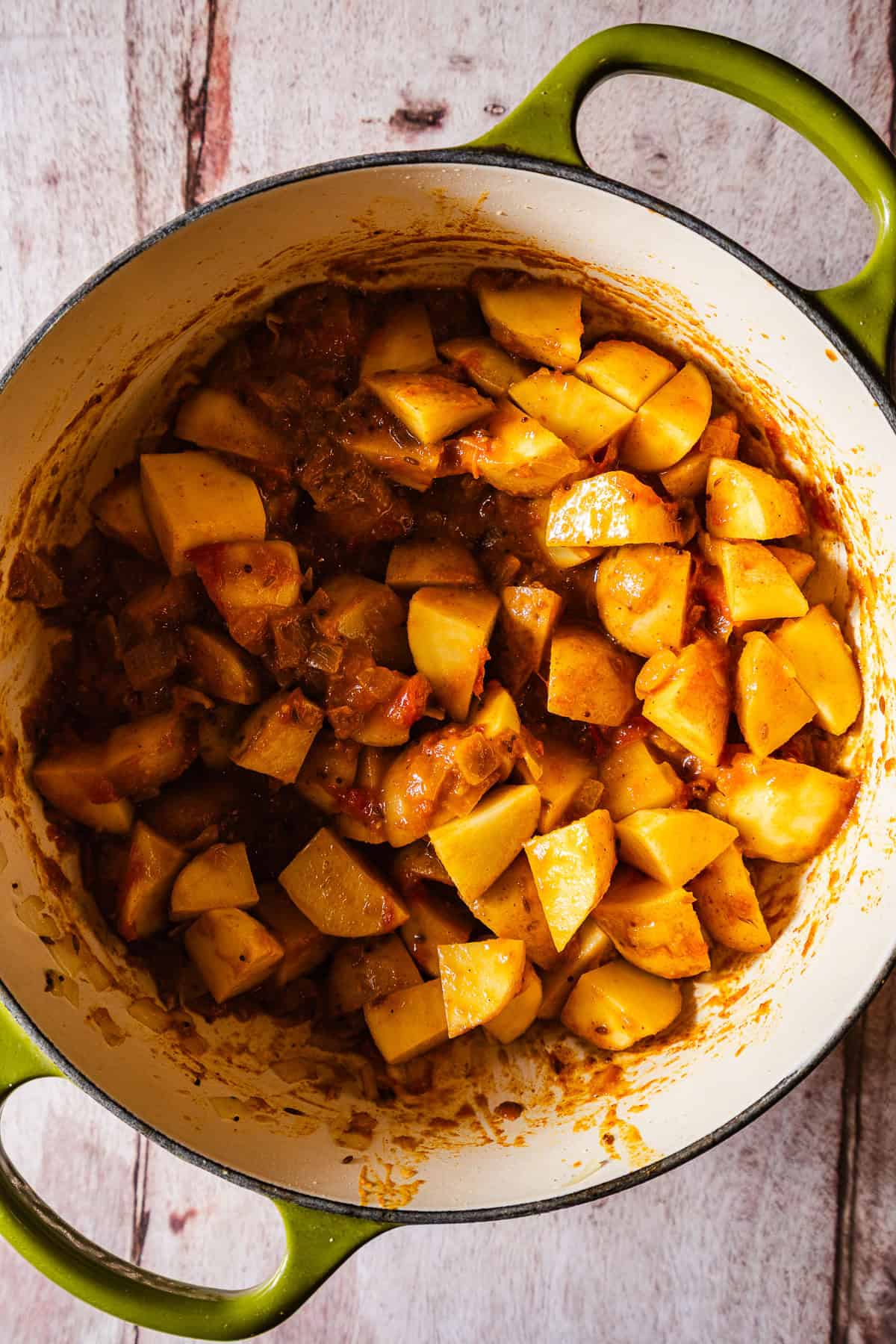 Raw potatoes in tomato gravy.