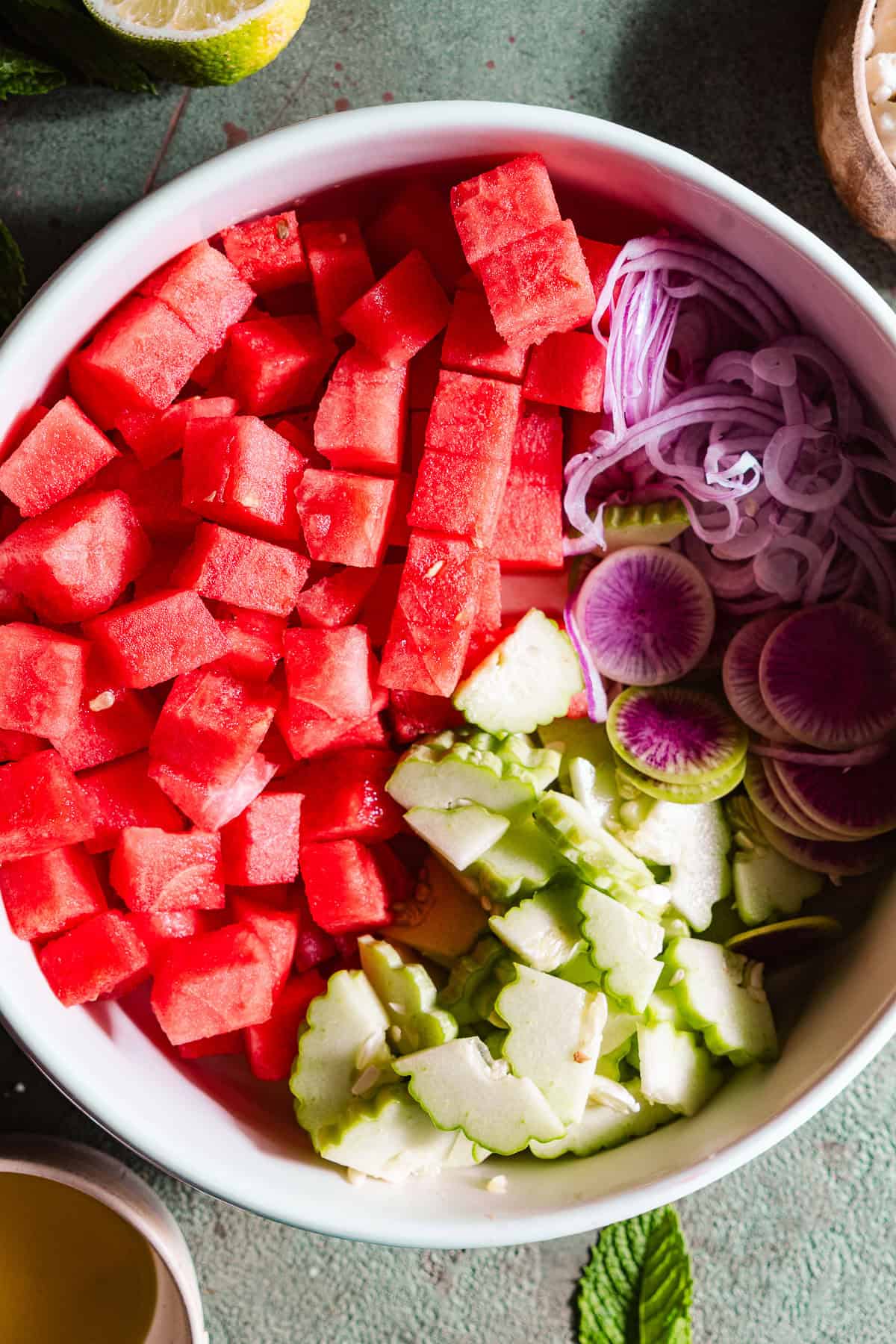 Chopped watermelon onion, radish, and cucumber.
