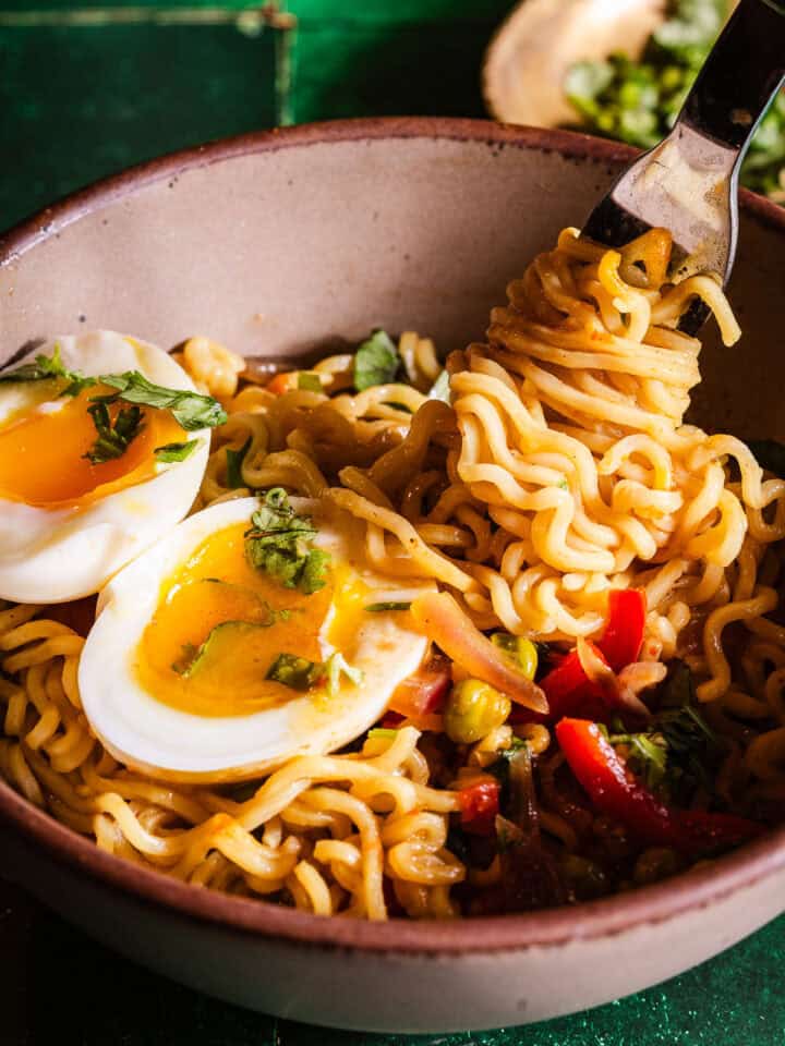 Noodle pull of a bowl of Egg Maggi Noodles.