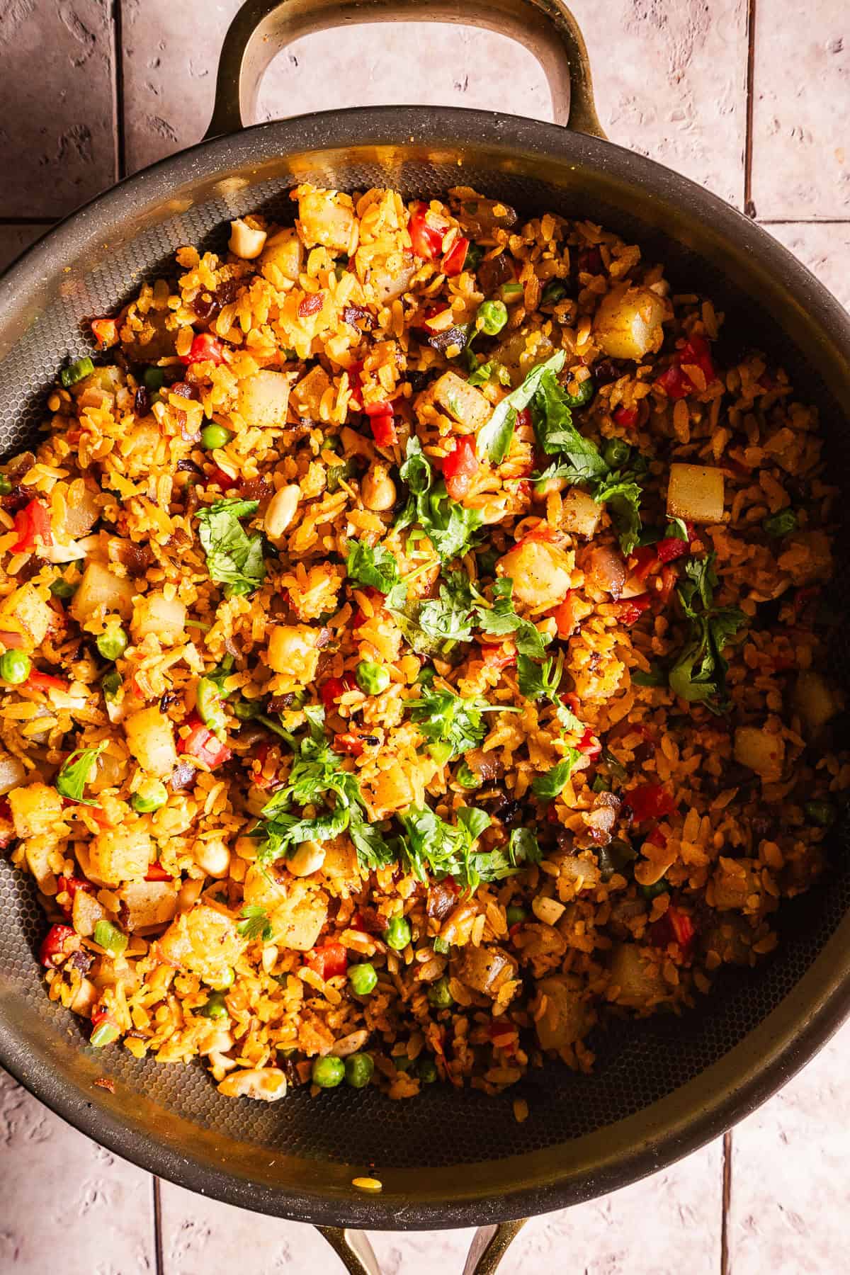 A vibrant vegetable poha dish featuring peanuts, peppers, and fresh herbs.