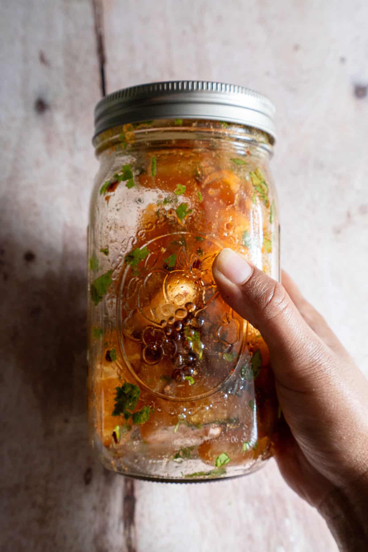 Orange chaat shaken in a mason jar.
